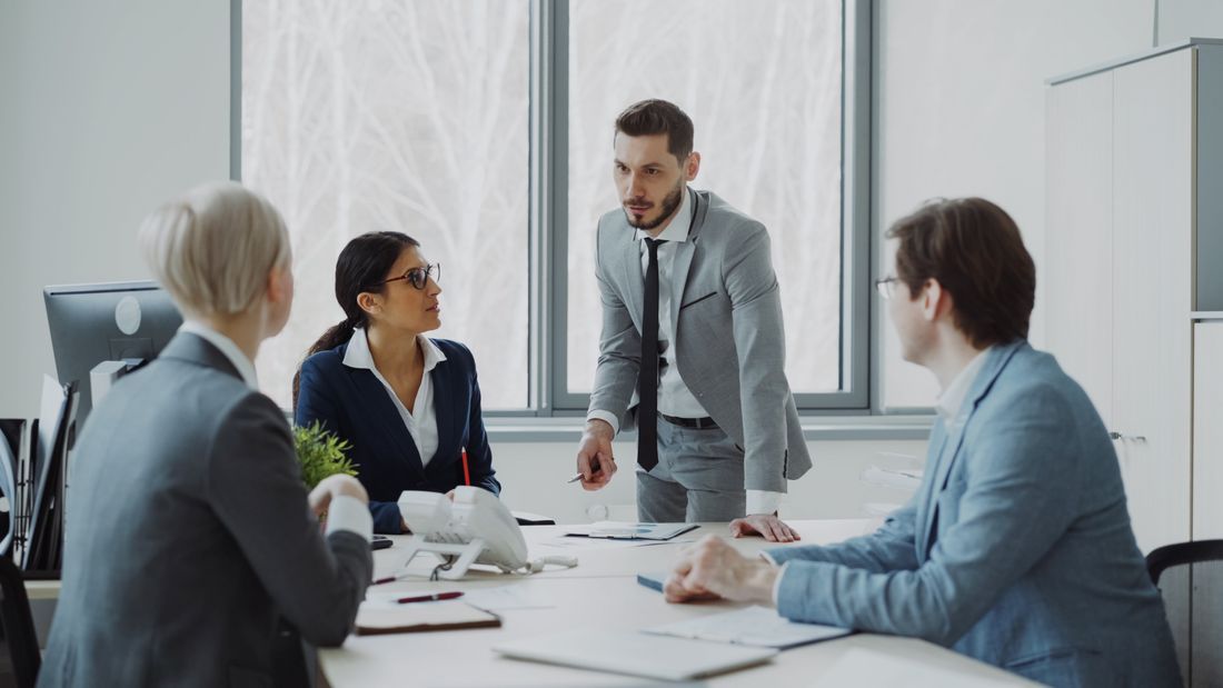 Manager mid-sentence with their team, others listening