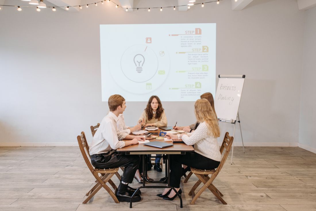 Facilitation moment — one person mid-sentence, others listening