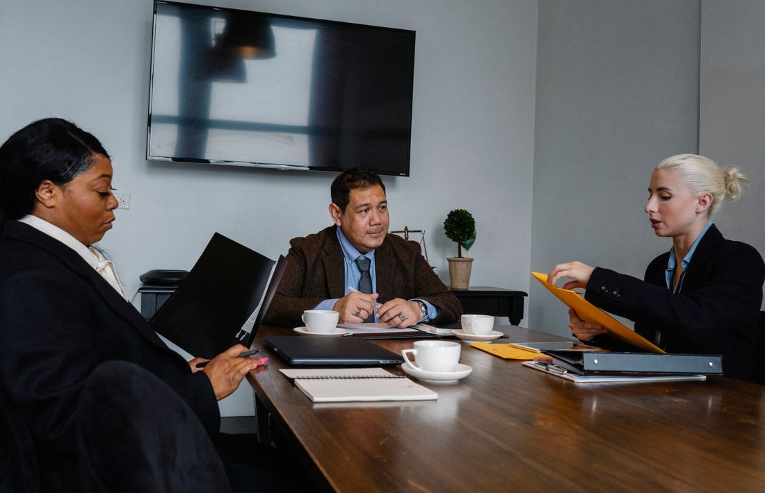 Public-sector team meeting, documents on the table